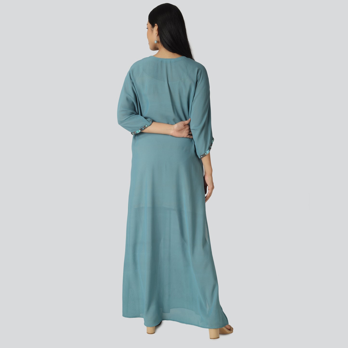 Blue kaftan dress backside showing lady