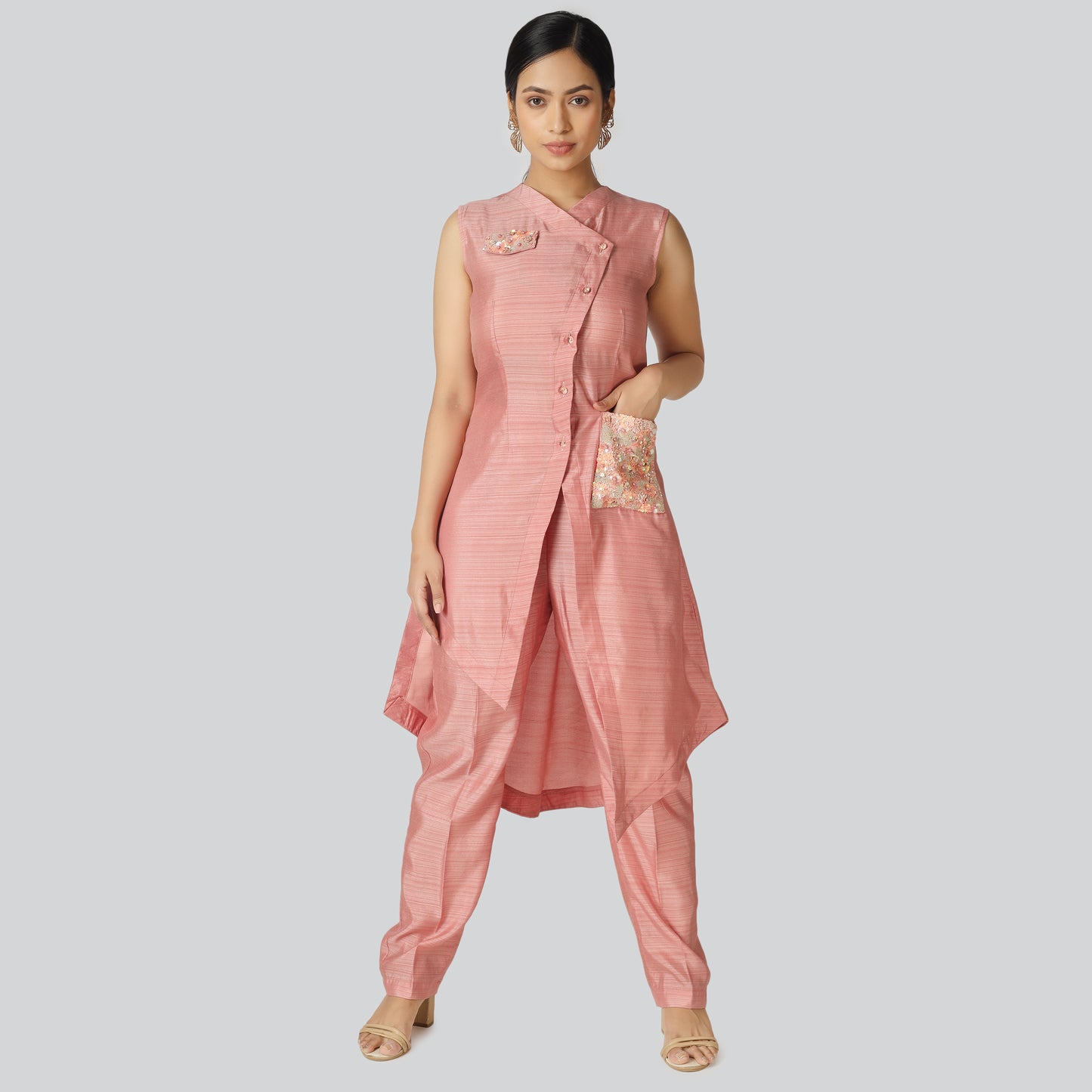 A lady wearing pink silk suit