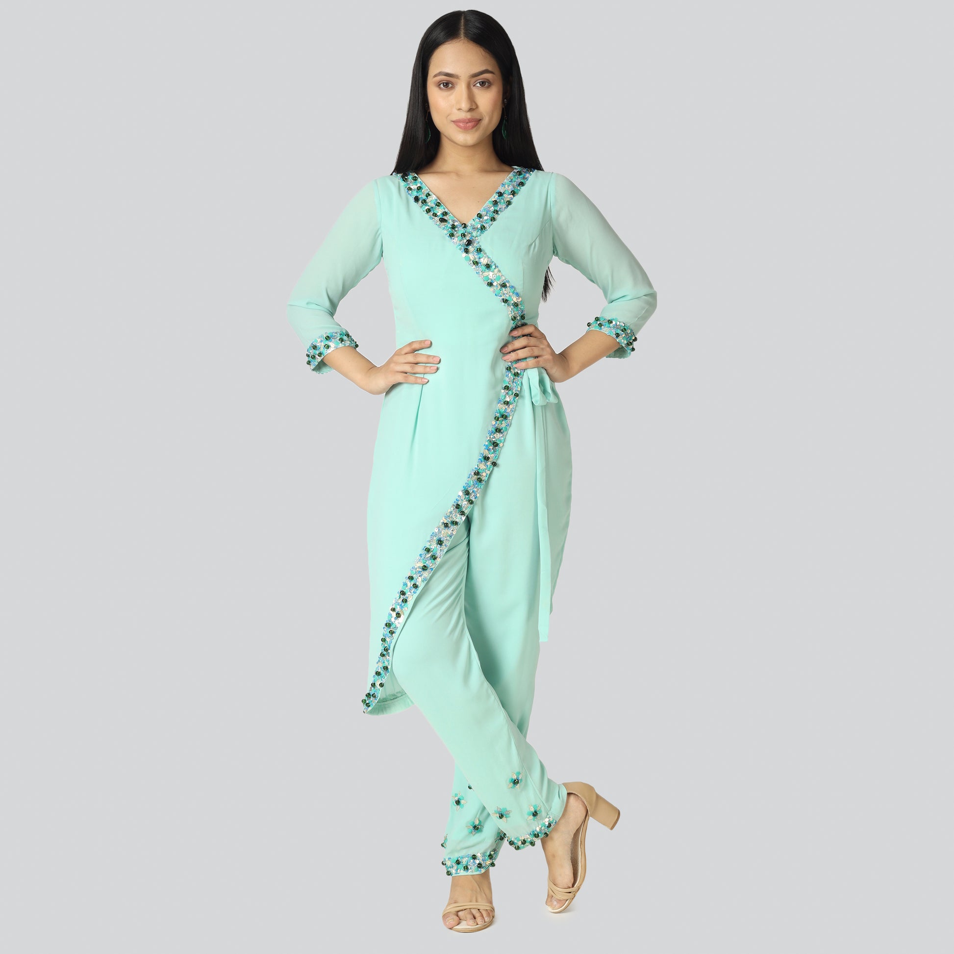 A girl wearing light green achkan style jumpsuit